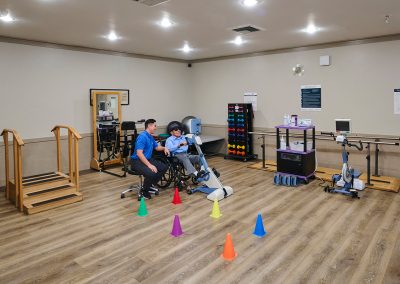 a rehab therapist and a resident in the rehab gym at Huntington Park Nursing Center